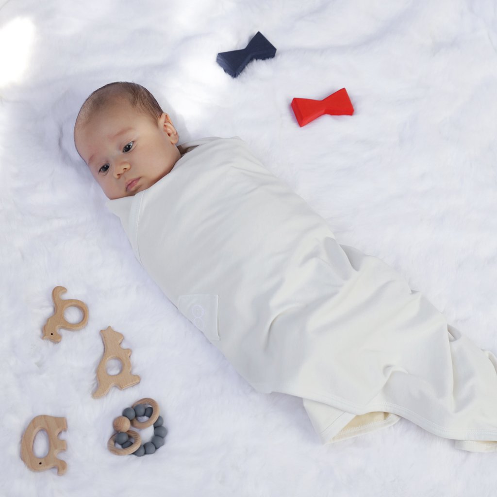 Baby snuggled up in Organic Swaddle Blanket